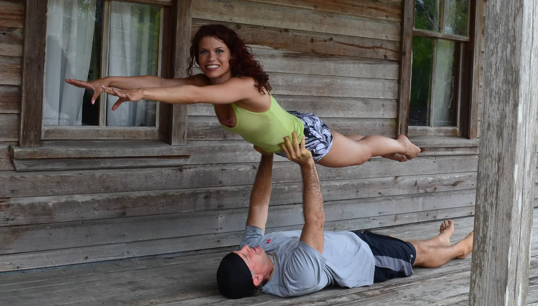 An acro pair on a wooden porch